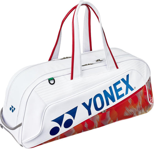 The Yonex 02631WEX Expert Tournament Tennis Bag in white features red handles, blue Yonex logo and name, a subtle red and gold pattern on the bottom edge, plus Thermo Guard technology to protect your gear at tournaments.