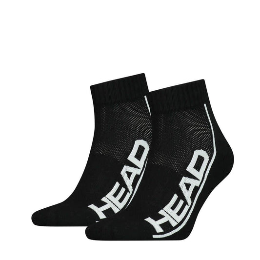 A pair from the HEAD Stripe Quarter Tennis Socks (2 Pack) in black, showcasing bold white "HEAD" lettering along the side. These socks offer cushioned soles and ribbed cuffs, featuring a mesh-like texture on top for breathability and added arch support for enhanced comfort.