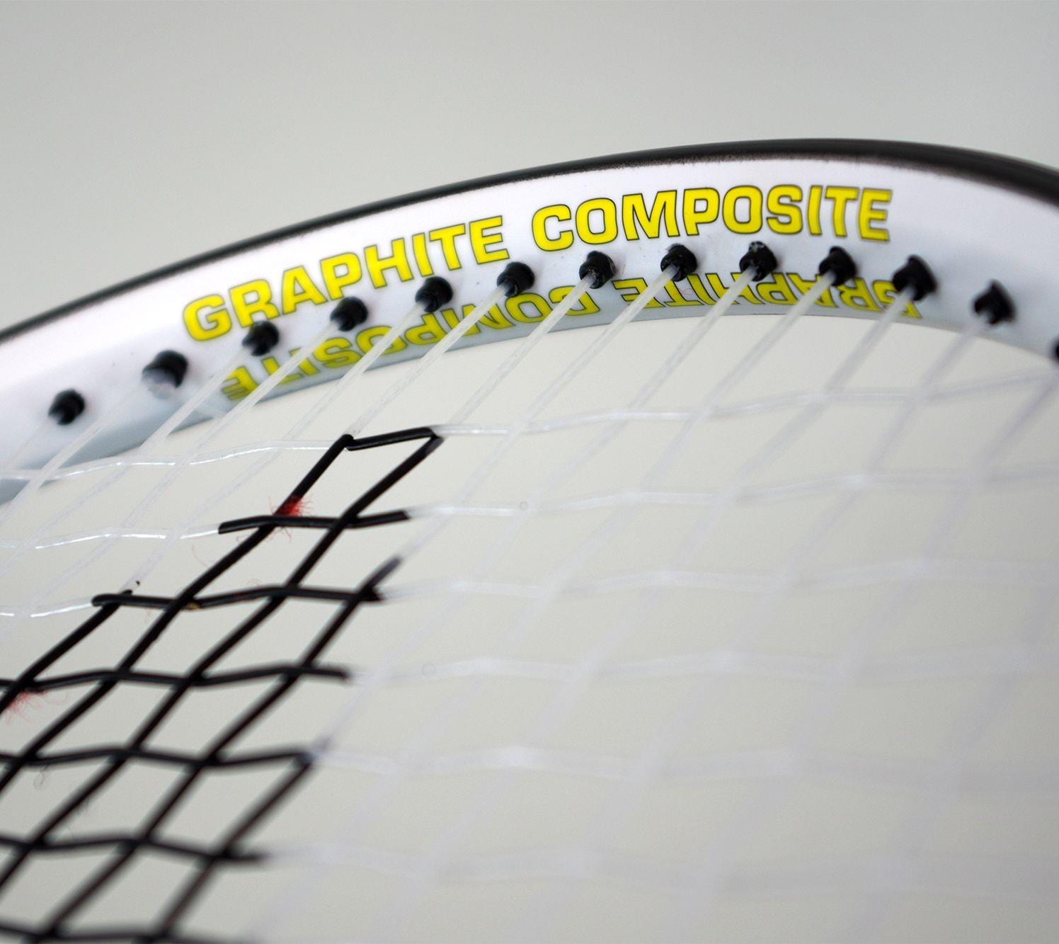 Close-up of a Karakal Pro Composite Tennis Racket - Black / White, featuring "Graphite Composite" printed in yellow on the frame. The tightly woven strings highlight its graphite composite construction, making it perfect for beginner to intermediate players.