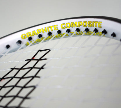 Close-up of a Karakal Pro Composite Tennis Racket - Black / White, featuring "Graphite Composite" printed in yellow on the frame. The tightly woven strings highlight its graphite composite construction, making it perfect for beginner to intermediate players.
